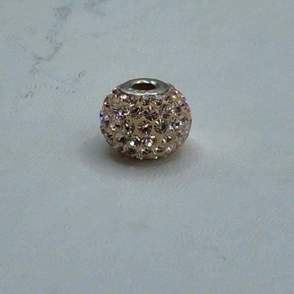 Sterling silver peachy shimmery slider bead that fits most bracelets.